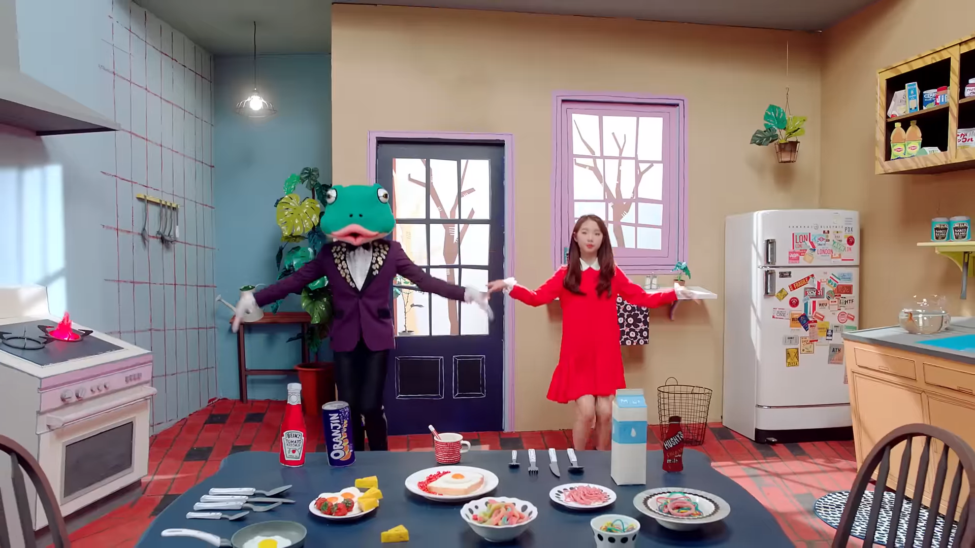 Yeojin and the frog dancing in the kitchen.